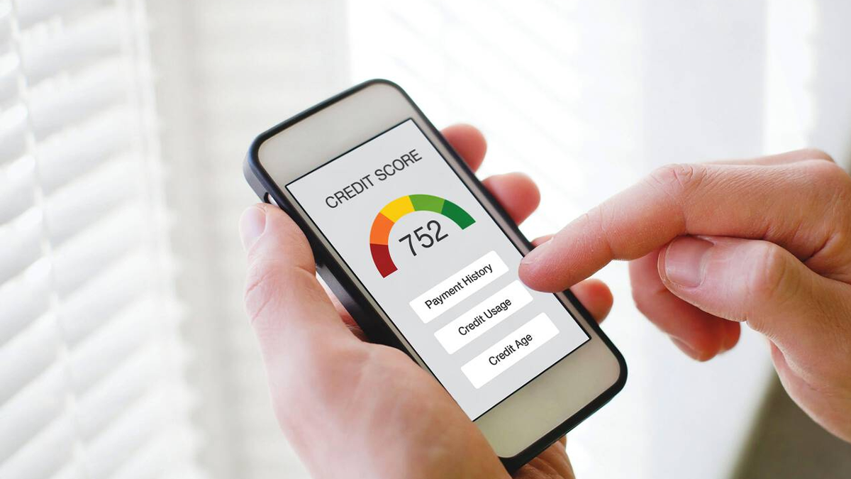 Hand scrolling through the phone, seeing his good credit and checking through the factors responsible for improving it.