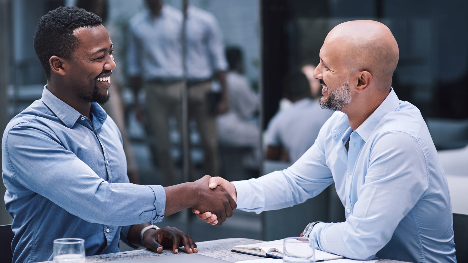 Two entrepreneurs shaking hands excitedly after finding out a great opportunity in credit repair
